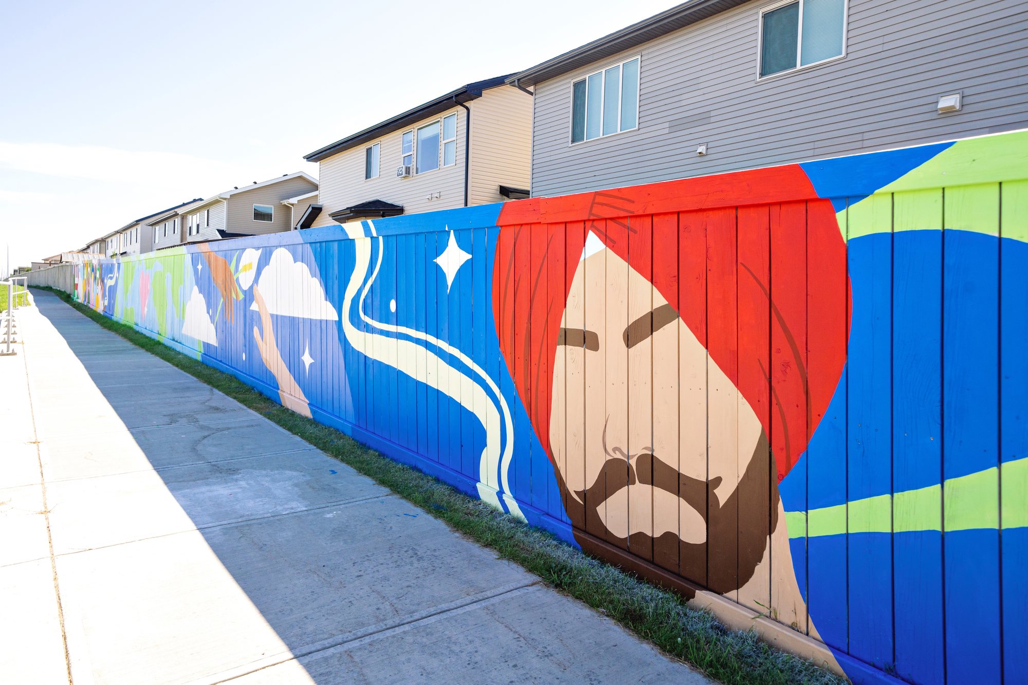 Vibrance in Diversity running along 80 Ave NE, a turbaned man in the foreground